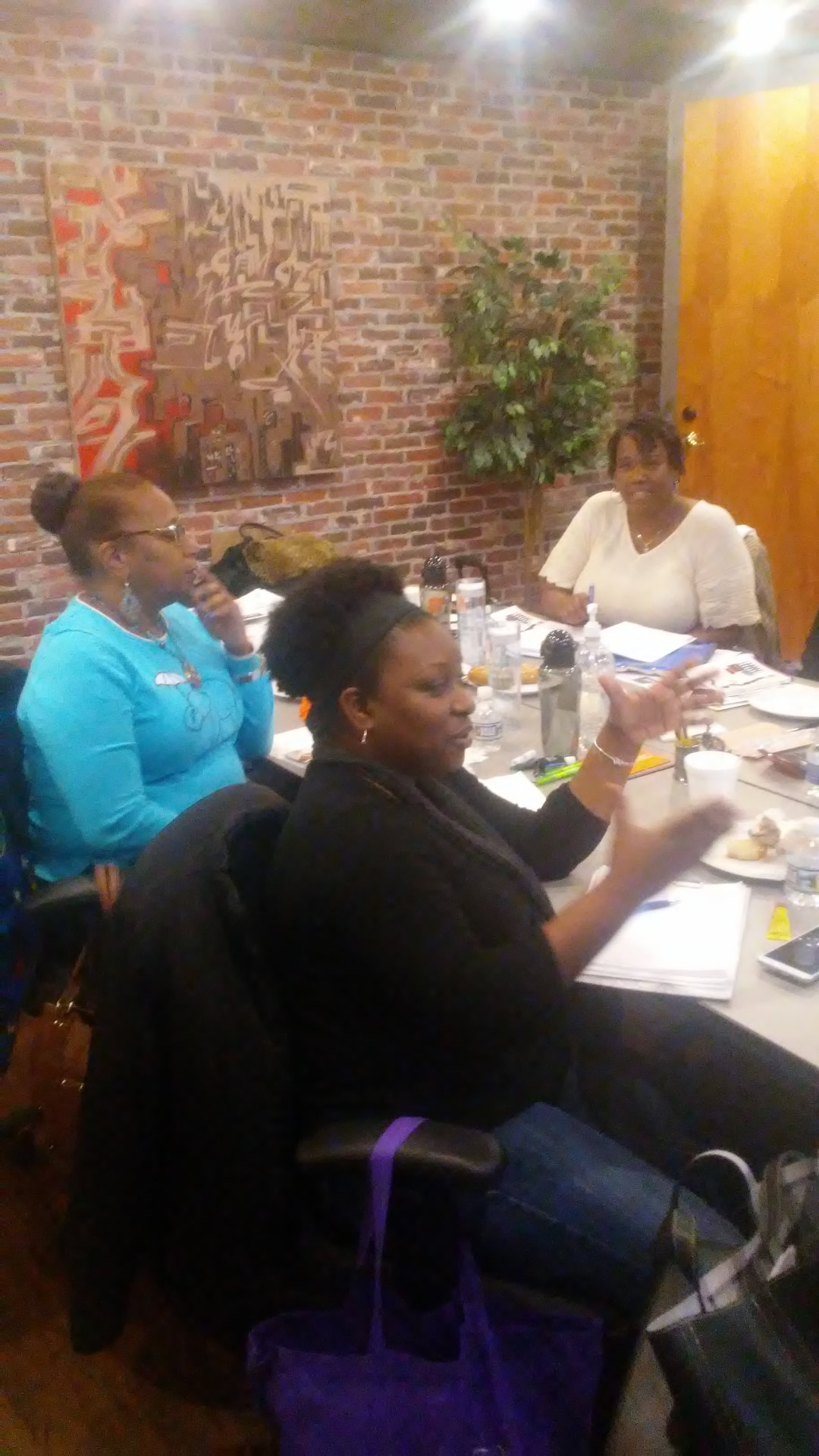 Women deep in discussion around a workshop table
