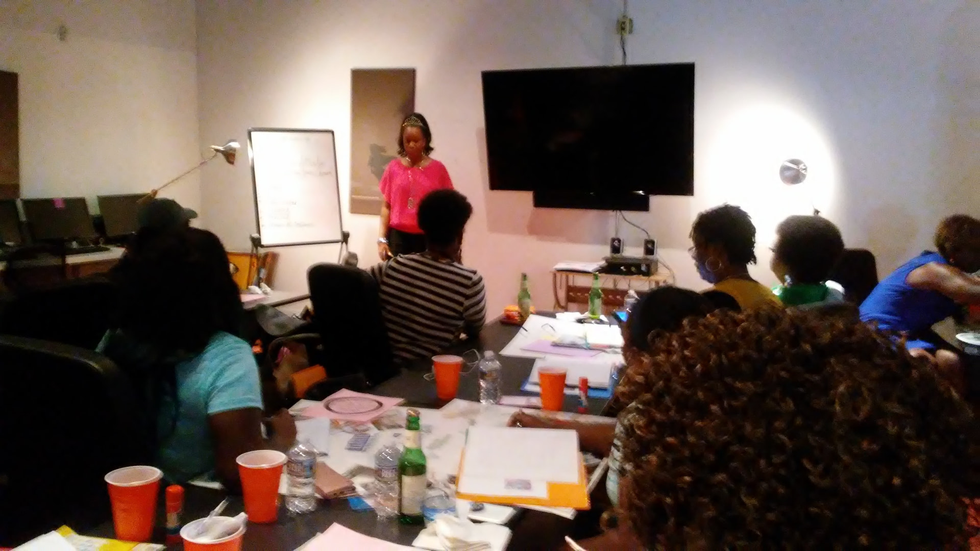 A facilitator in pink sharing with the group during the Crown session