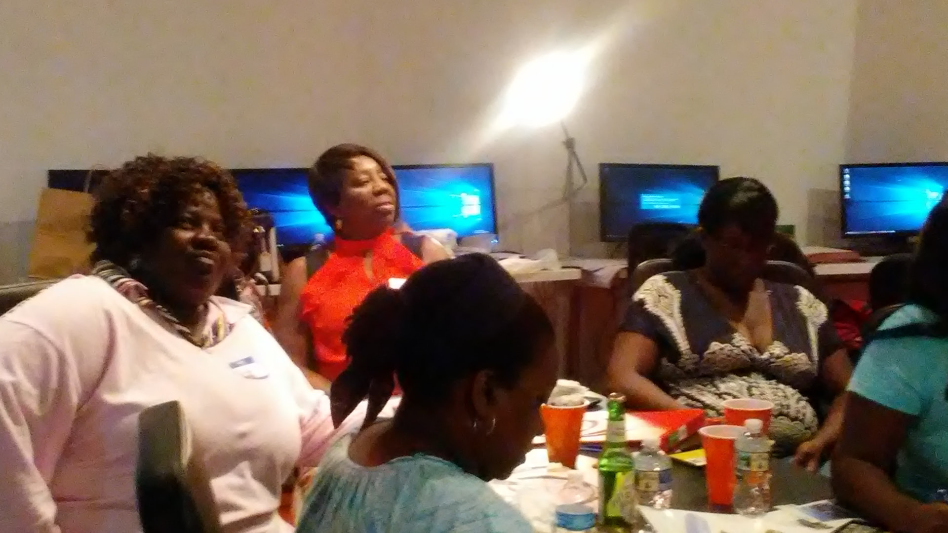 Women laughing together around the workshop tables