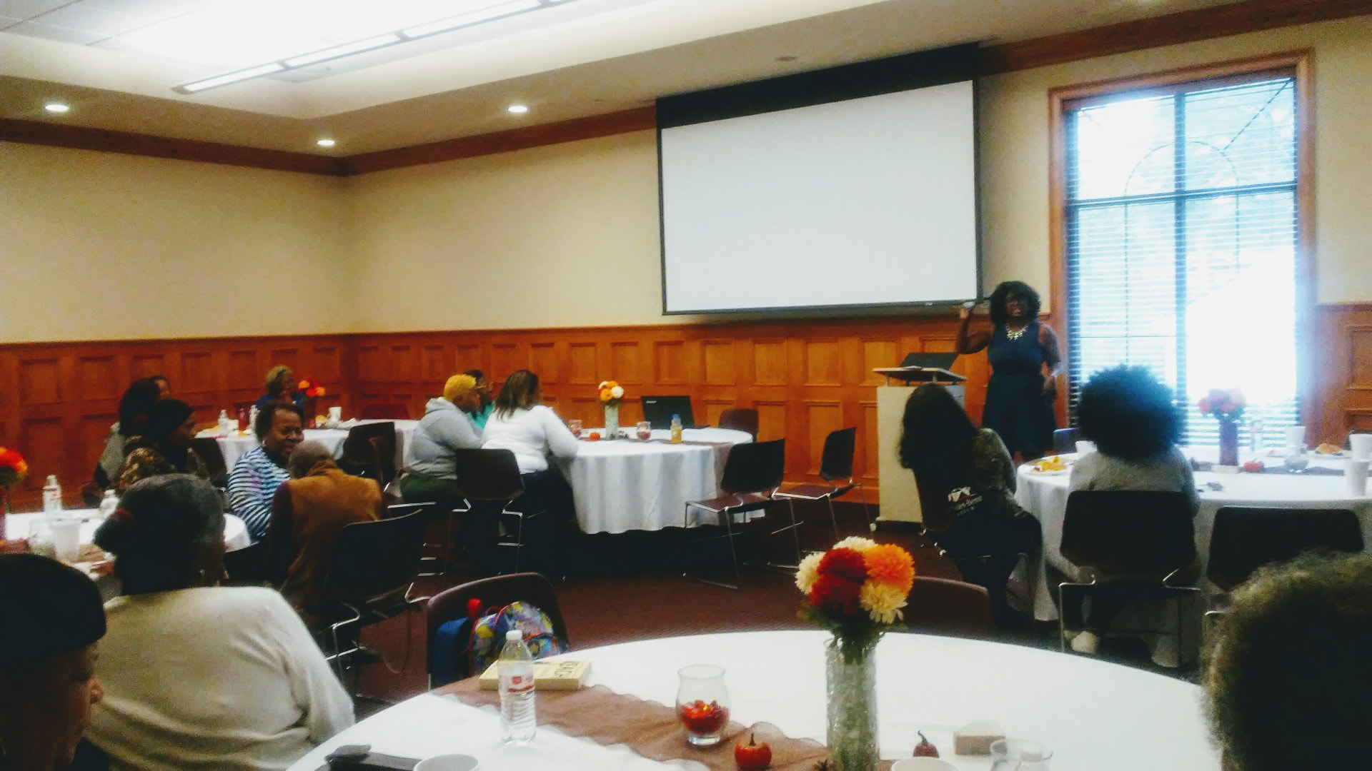 A speaker at the podium addressing the room