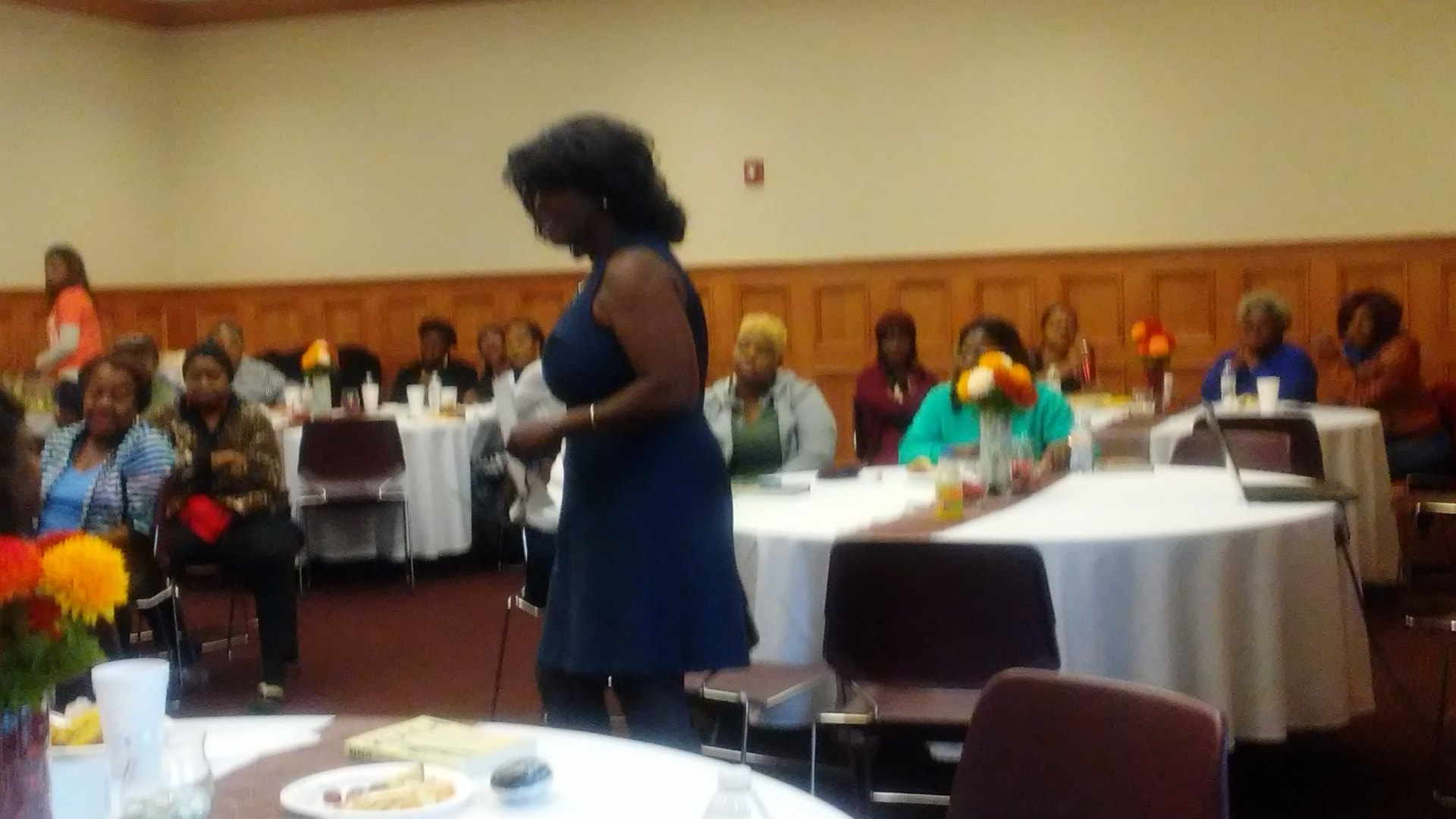 A speaker sharing her story at a 5M banquet gathering