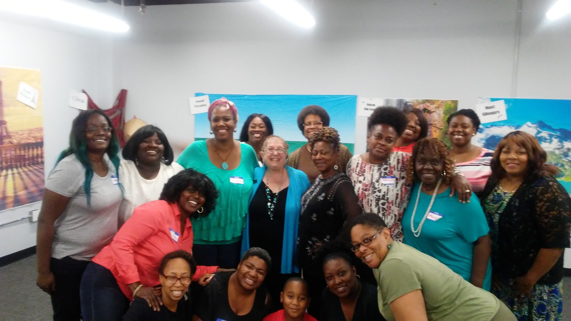 The full 5M cohort posing together in front of travel posters