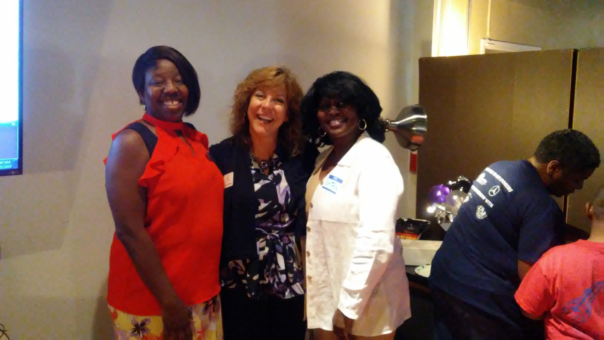 Three women smiling together after a session